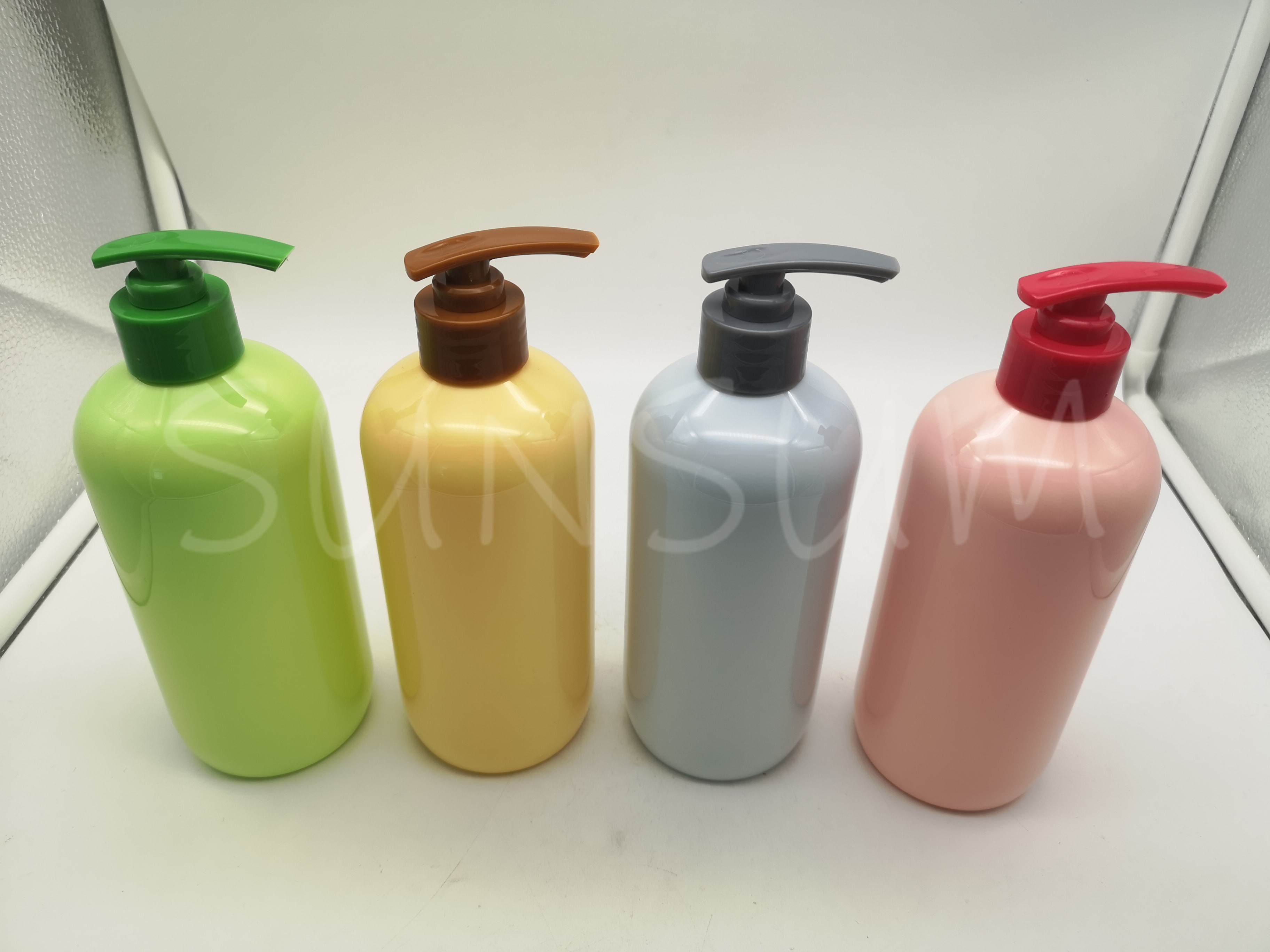 Candy colored shampoo hair care bottle